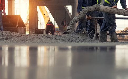 Concrete pouring during commercial concreting floors of building on construction site
