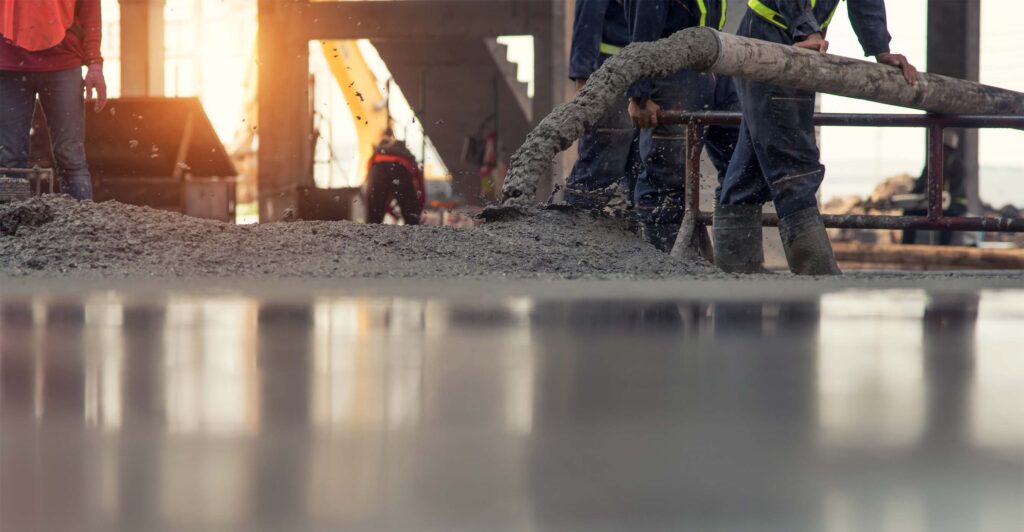 Concrete pouring during commercial concreting floors of building on construction site